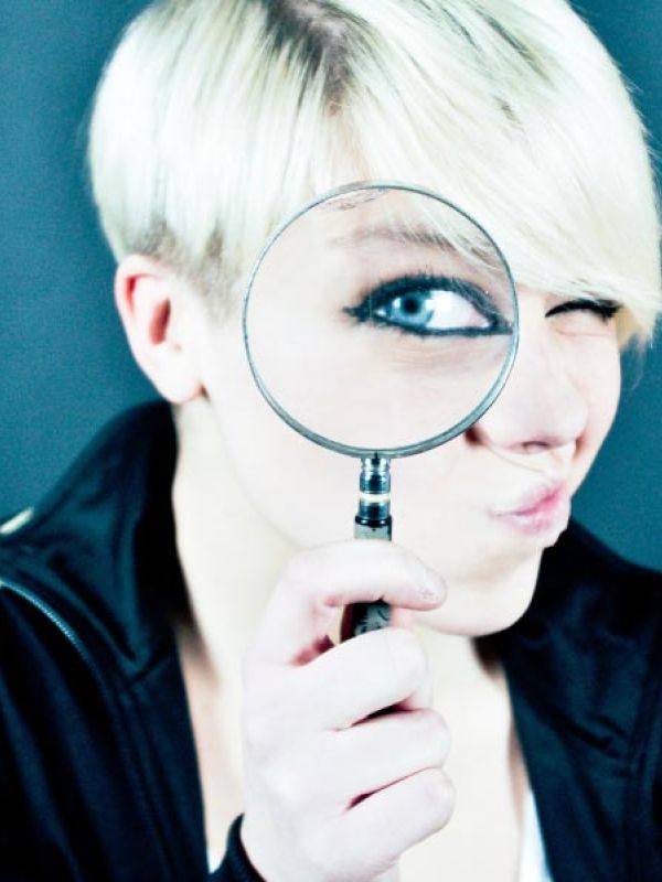 Visage avec une loupe devant un oeil